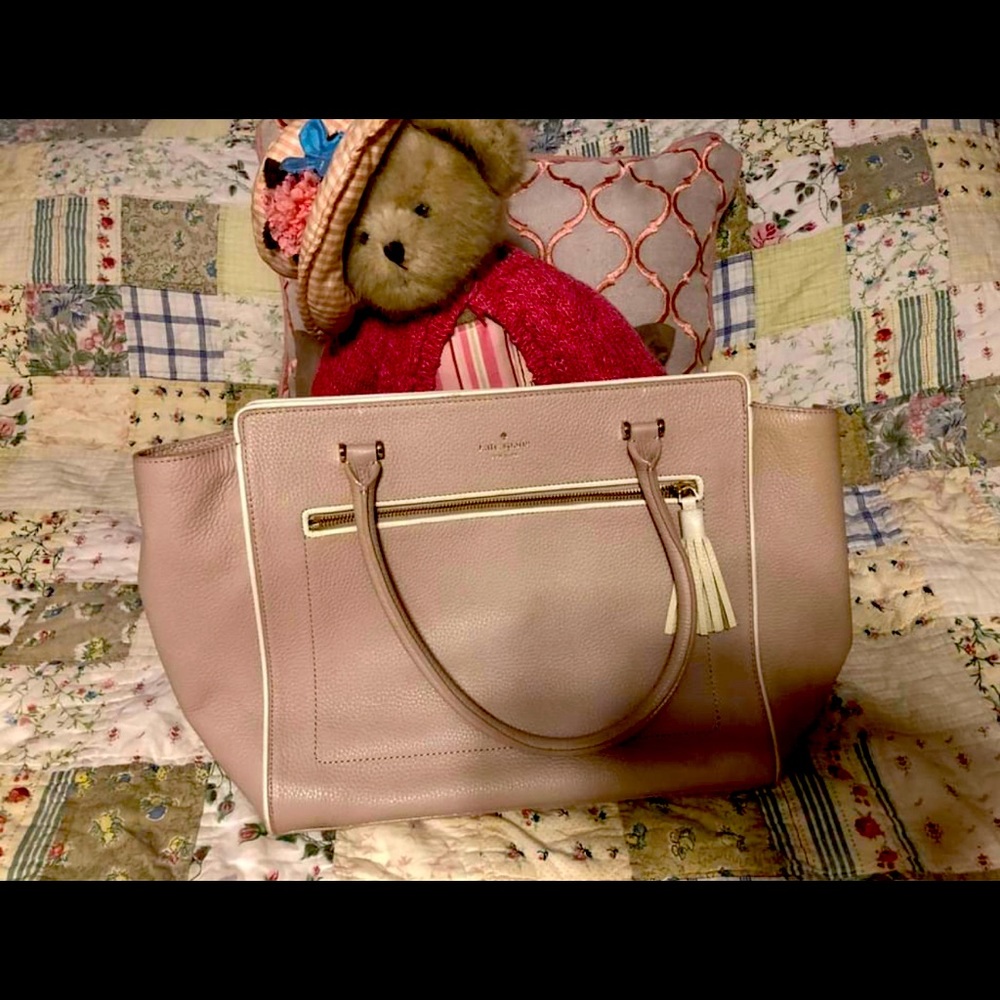Kate Spade pocketbook The color is somewhere in between a pale pink and a tan.